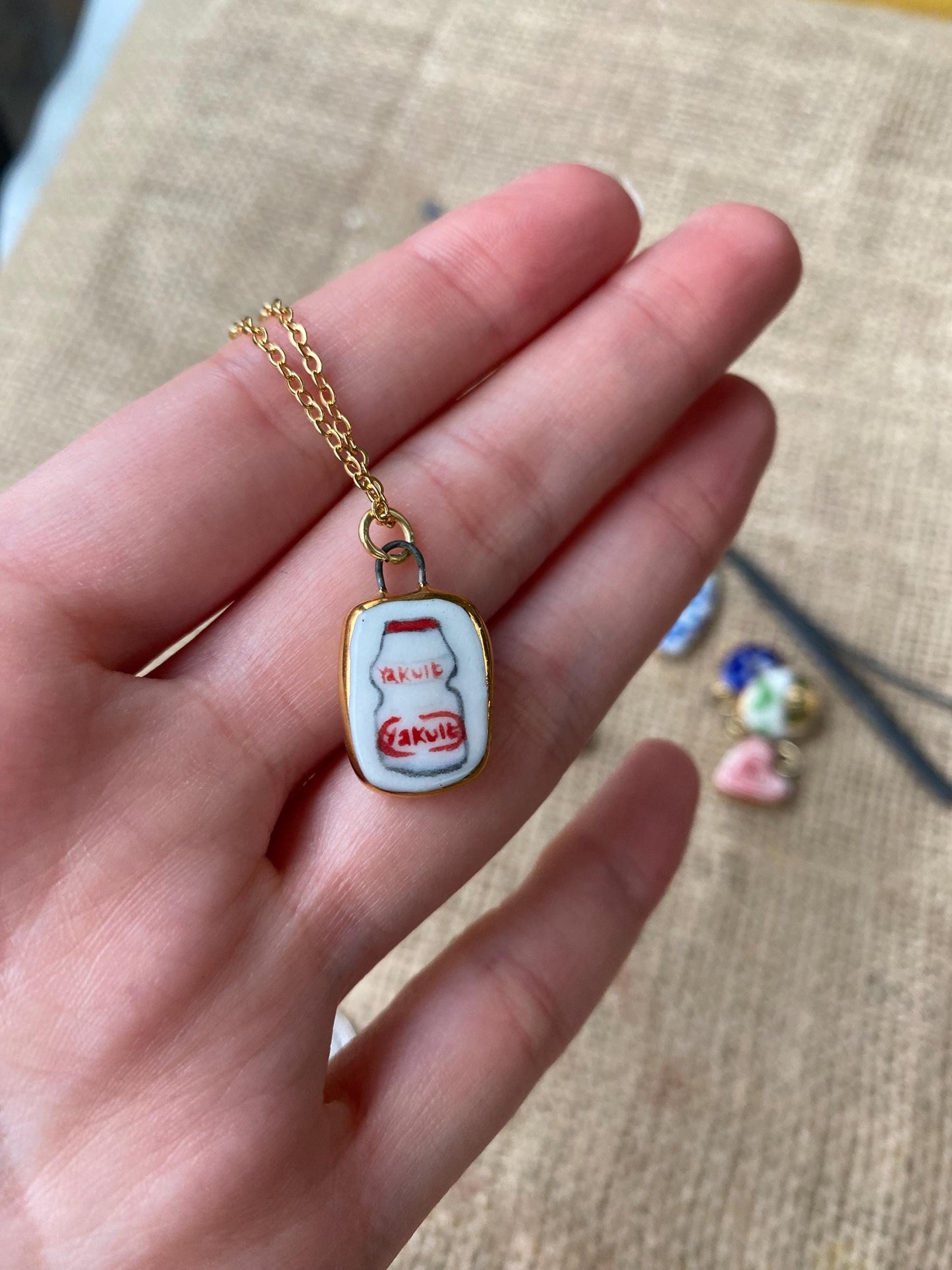 Hand-Sculpted Porcelain Yakult Pendant: 24k Gold Lustre Ceramic Necklace Charm